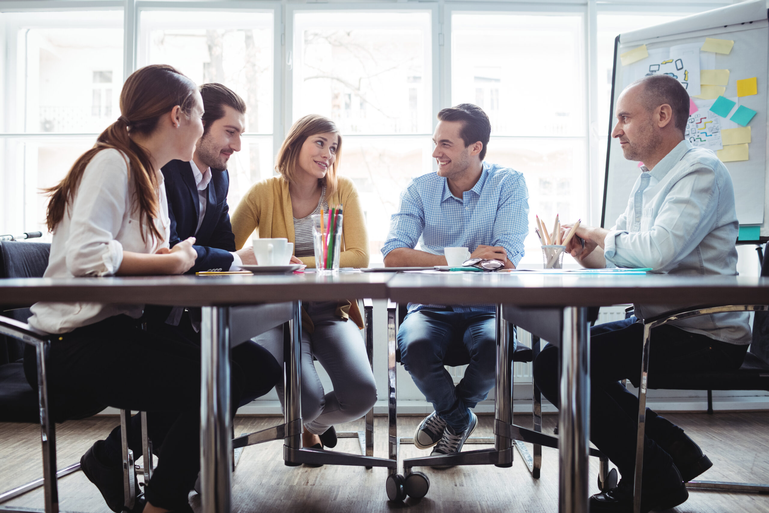 Coworkers discussing in meeting room at creative office